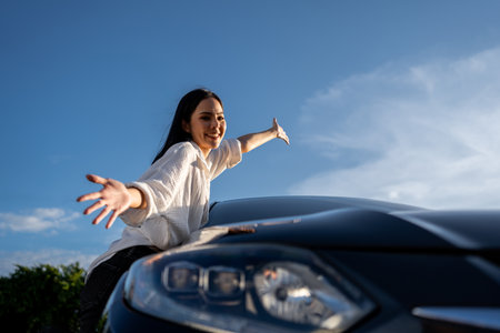 Young beautiful asian women buying new car. she was standing near car on the roadside. Beautiful...