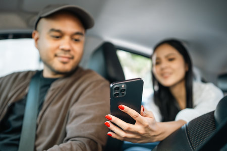 Young asian woman traveler talking with taxi driver explain the route how to travel in direction...