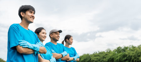 Happy volunteer people group charity with garbage bags cleaning up in park. Corporate social responsibility and society activity for Environment . Ecology and CSR concept.の写真素材