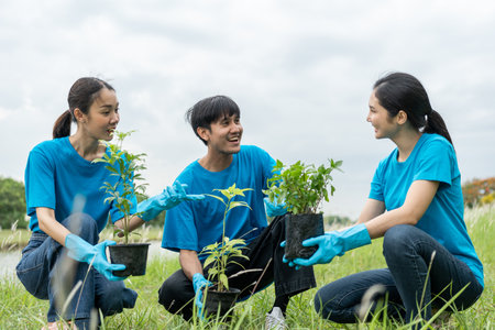 Volunteering Protection of environment and nature ecology concept. Group of volunteer plant a tree Plant trees water them till the soil. Nature for sustainable environment.Global warming concept.の写真素材