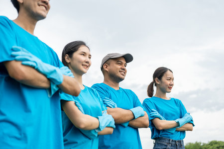 Happy volunteer people group charity with garbage bags cleaning up in park. Corporate social responsibility and society activity for Environment . Ecology and CSR concept.の写真素材
