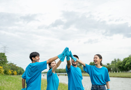 Happy volunteer people group charity with garbage bags cleaning up in park. Corporate social responsibility and society activity for Environment . Ecology and CSR concept.の写真素材