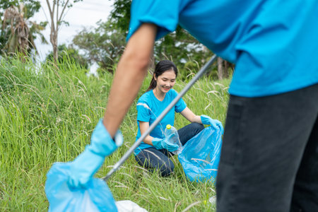 Happy volunteer people group charity with garbage bags cleaning up in park. Corporate social responsibility and society activity for Environment . Ecology and CSR concept.の写真素材
