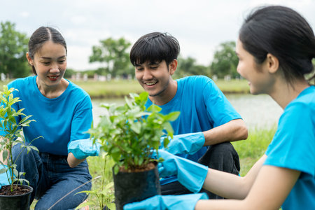 Volunteering Protection of environment and nature ecology concept. Group of volunteer plant a tree Plant trees water them till the soil. Nature for sustainable environment.Global warming concept.の写真素材