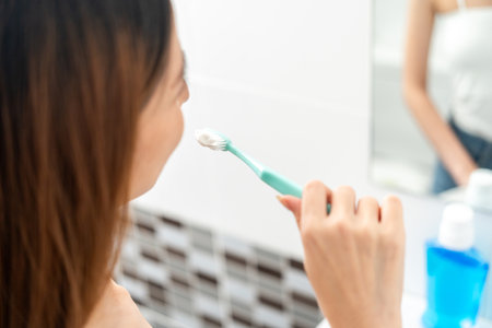 Young smiling asian woman holding brush teeth for the health of teeth in restroom. Take care and good dental health fresh breathの写真素材