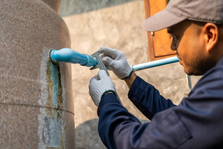 Male Plumber worker installation pipe system hand holding the water tap faucet. Plumbing checking service and repair.の写真素材