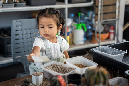 Happy family mother and her daughter concept, asian young mom and baby girl spending time together with planting, parent and her child doing hobby, the quality time for children activities at home.の写真素材