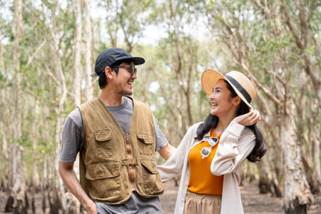 Happy asian couple traveling in the forest. Happy man and female travel weekend on vacation time...