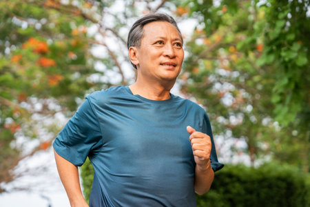Senior old man runner exercise outdoor nature park. fitness man jogging wearing sportswear. Mature athlete man in sportswear Workout running at public park. Health and activity old man lifestyleの写真素材