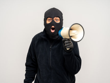 Thief in uniform black jacket various pose on isolated background. The Robber terrorism criminal escapes with balaclava and crowbar entering a house for stealing Housebreakの写真素材