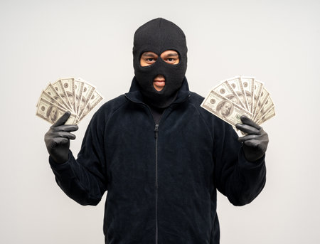 Thief in uniform black jacket various pose on isolated background. The Robber terrorism criminal escapes with balaclava and crowbar entering a house for stealing Housebreakの写真素材