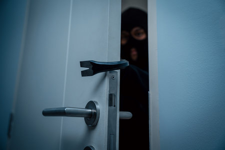 Thief in uniform black jacket various action housebreak. The Robber terrorism criminal escapes with balaclava and crowbar entering a house for stealing Housebreak at nightの写真素材