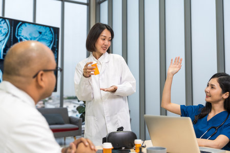 Medical team doctor planning research in a hospital and talking about patient symptoms as results x ray film. Discussion healthcare meeting group speaking about medicine strategy various actionの写真素材