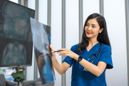 Medical team doctor planning research in a hospital and talking about patient symptoms as results x ray film. Discussion healthcare meeting group speaking about medicine strategy various actionの写真素材