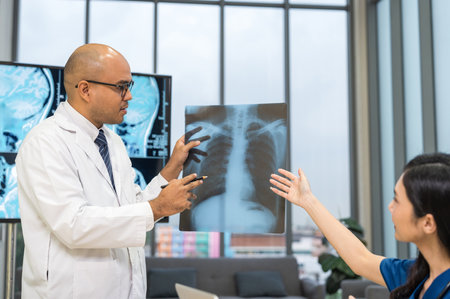 Medical team doctor planning research in a hospital and talking about patient symptoms as results x ray film. Discussion healthcare meeting group speaking about medicine strategy various actionの写真素材