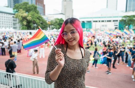 Celebrate in pride month festival. Pride movement transgender asian lesbian LGBT holding rainbow flag for freedom. Gatherings of friends in parade communities celebrating LGBTQ+ causes.の写真素材