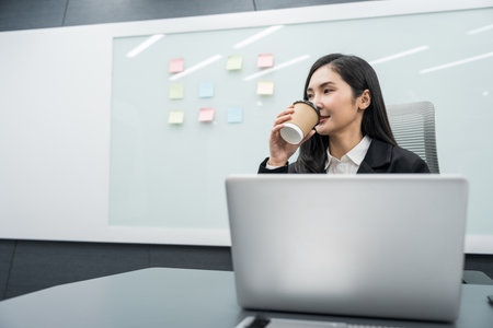 Young asian businesswoman working with laptop in the office. CEO Businesswoman analyzing statistics financial Meeting Conference Discussion various topic Corporateの写真素材