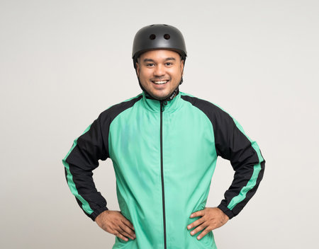 Young asian rider wearing green jacket uniform and bike helmet standing various action on isolated white background. Male delivery service worker. Delivery courier and shipping food service.の写真素材