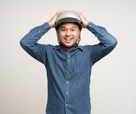 Young rider man wearing safety helmet before riding the motorcycle. Safety ride.の写真素材