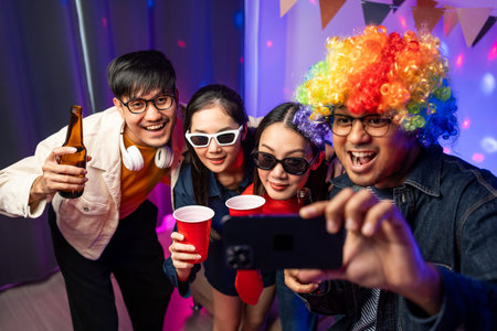 New Year's Party. Group of asian friend party in the house with disco light having fun and dancing...