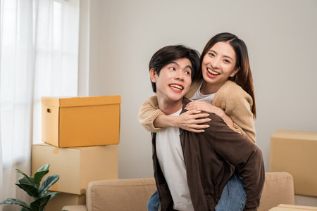 Couple asian family buying new house. Happy moment man and woman getting new home moving parcels...