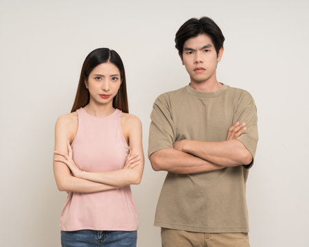 Bad relationship unhappy asian couple quarreling in various action gesture standing on isolated white background. Shouting angry man and woman stressed has problem in Married lifeの写真素材