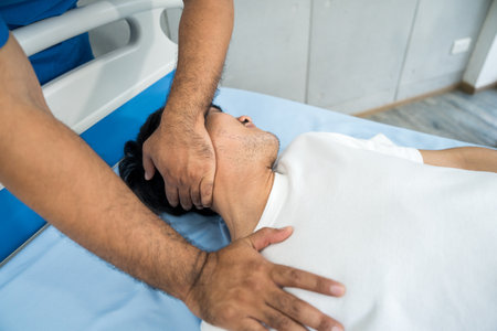 Physical therapy. Male Nurse aids young man in recovering from spine injury and providing orthopedic massage Orthopedic healthcare and chiropractor with person for physical therapy rehabilitationの写真素材