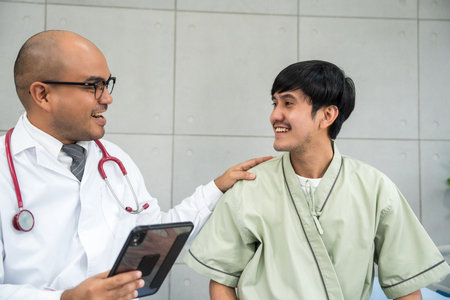 Doctors encourage patients recovery service. Doctors treat patients diseases. Life and health insurance. Advice to young man consulting about treatmentの写真素材