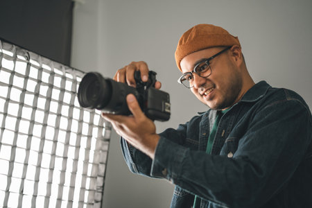 Professional man photographer working shooting woman model using digital camera and flash studio in studio on white background. photography concept.の写真素材