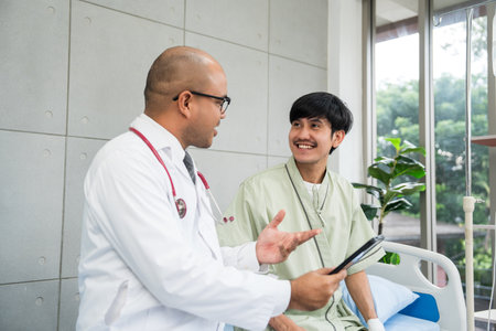 Doctors encourage patients recovery service. Doctors treat patients diseases. Life and health insurance. Advice to young man consulting about treatmentの写真素材