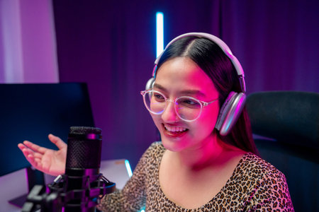 Content creator woman host streaming her a podcast with headphones and microphone interview cheering...