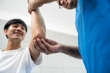 Physical therapy. Male Nurse aids young man in recovering from spine injury and providing orthopedic massage Orthopedic healthcare and chiropractor with person for physical therapy rehabilitationの写真素材