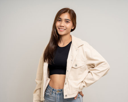 Beautiful smiling happy young asian woman age around 25. Charming female lady standing pose on isolated white background. Asian woman people confident with backdrop.の写真素材
