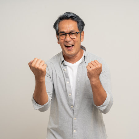 Handsome asian mature old man standing on isolated white background. Happy Portrait of cheerful...