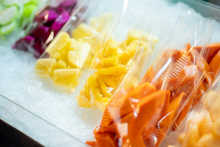 Various fruits on ice shelf at street food marketの写真素材