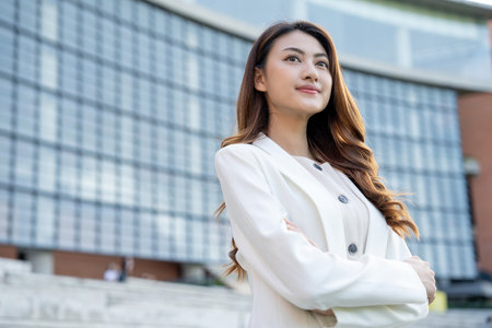 Portrait beautiful Businesswoman in suit standing at the buildings downtown. Confident woman looking towards their goals for success.の写真素材