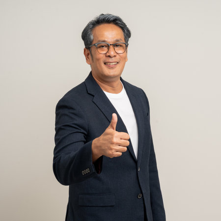 Handsome asian mature old man standing on isolated white background. Happy Portrait of cheerful...