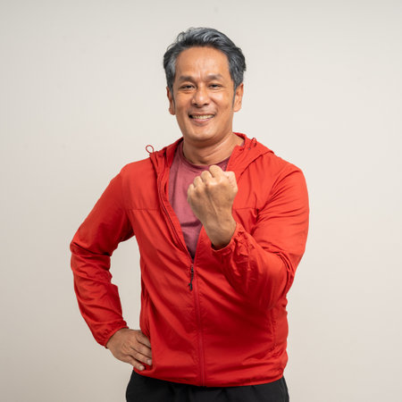 Senior asian old man with sportswear on isolated white background. Portrait happy healthy fit and...