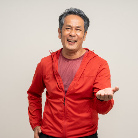 Senior asian old man with sportswear on isolated white background. Portrait happy healthy fit and firm attractive sporty mature man standing pose exercise workout in studio.の写真素材