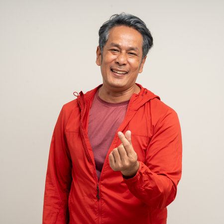Senior asian old man with sportswear on isolated white background. Portrait happy healthy fit and firm attractive sporty mature man standing pose exercise workout in studio.の写真素材