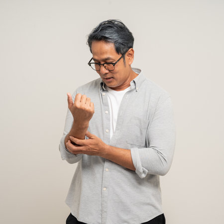 Senior asian old man has an inflamed elbow. Old man senior has problem with structural postureの写真素材
