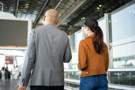 Portrait of confident young business people smiling at camera while standing in the international airport terminal.の写真素材
