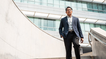 Senior manager business man in suit standing at the buildings downtown. Confident man looking...