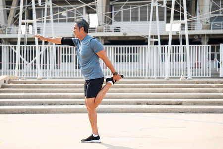 Senior old asian man wearing sportswear warming up before running outdoor. Portraits of Mature man...