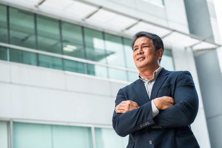 Senior manager business man in suit standing at the buildings downtown. Confident man looking...