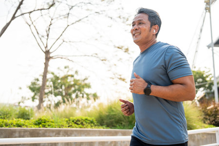 Senior old man runner exercise outdoor nature park. fitness man jogging wearing sportswear. Mature athlete man in sportswear Workout running at outdoor. Health and activity old man lifestyleの写真素材