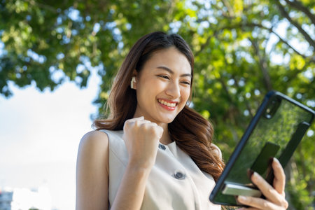Portrait beautiful Businesswoman in suit with tablet standing at the buildings downtown. Confident woman using tablet. Executive Smart businessmanの写真素材