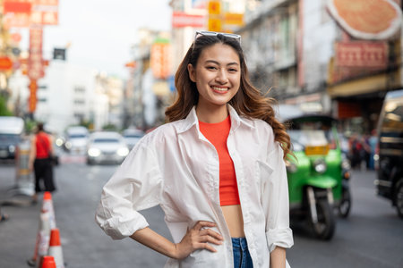 Asian woman enjoy eating street food at night market. Traveler Asian blogger women Happy tourists Beautiful female with Traditional food local road at thailand bangkok city.の写真素材