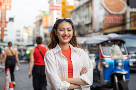 Asian woman enjoy eating street food at night market. Traveler Asian blogger women Happy tourists Beautiful female with Traditional food local road at thailand bangkok city.の写真素材