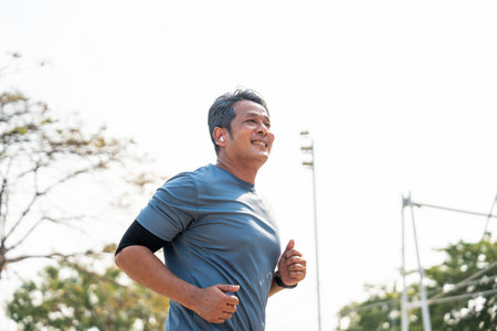 Senior old man runner exercise outdoor nature park. fitness man jogging wearing sportswear. Mature athlete man in sportswear Workout running at outdoor. Health and activity old man lifestyleの写真素材